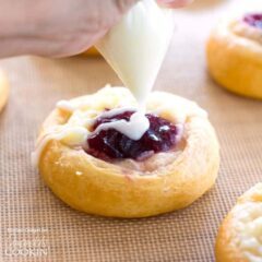 squeezing glaze onto pastry