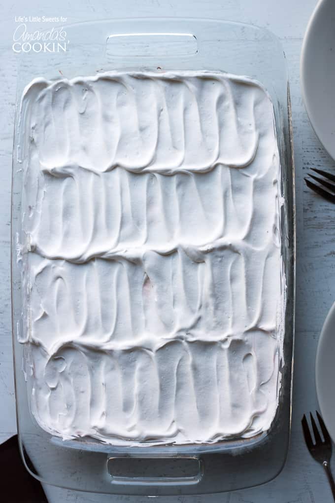 Red Velvet Lasagna Dessert in pan with whipped topping