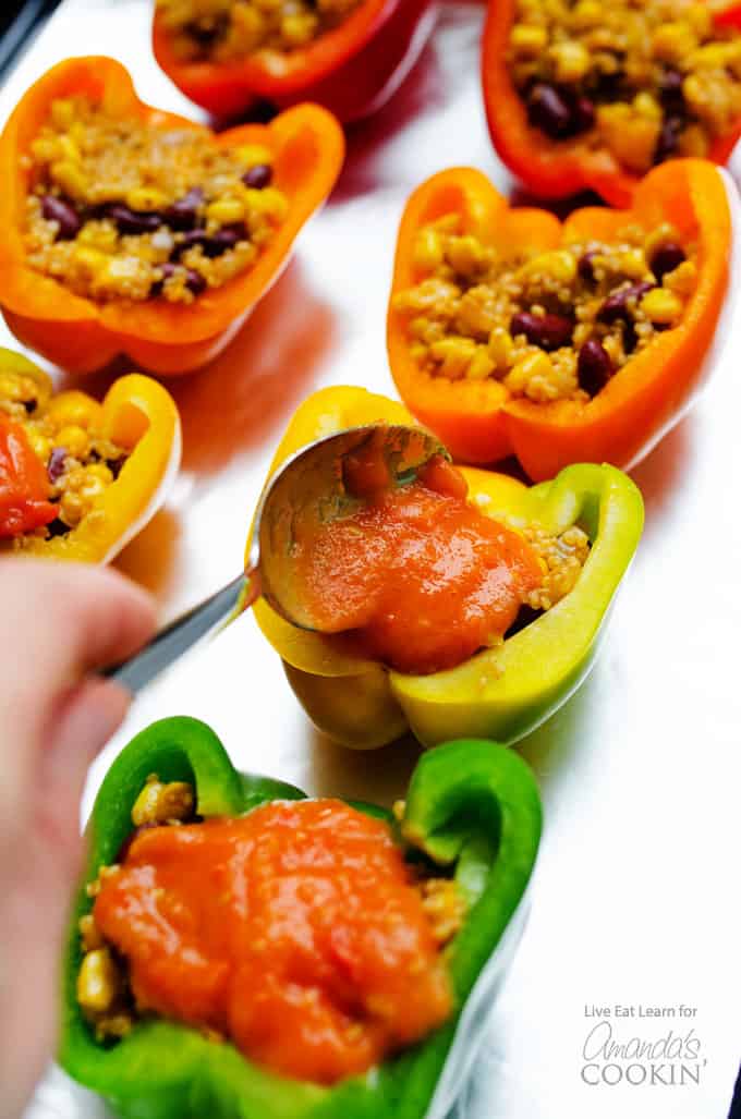 Adding sauce to enchilada stuffed peppers