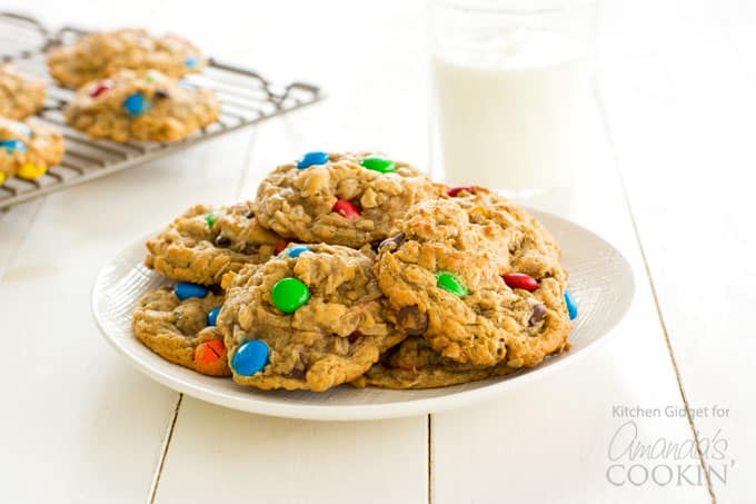 Monster cookies on a plate with a glass of milk