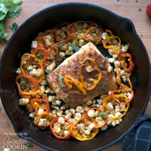 cast iron pan with cod and vegetables