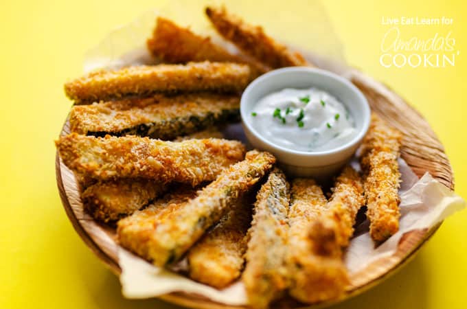 crispy baked zucchini fries on a plate with dipping sauce