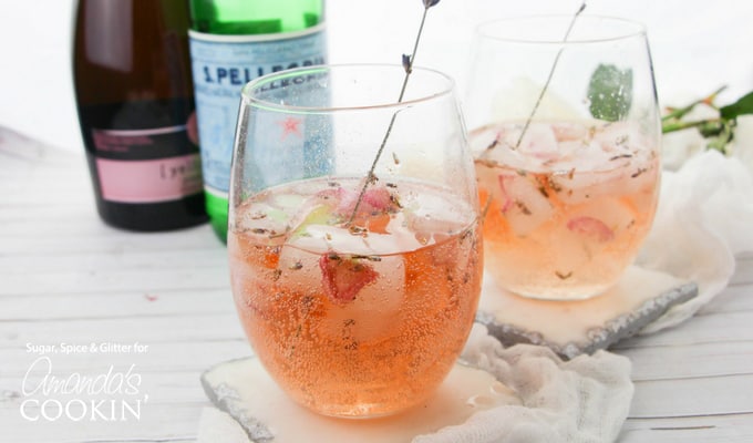 lavender rose spritzer in wine glass with lavender garnish