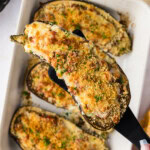 spatula lifting a stuffed baked eggplant parmesan