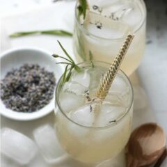overhead view of lavender lemonade with gold straws