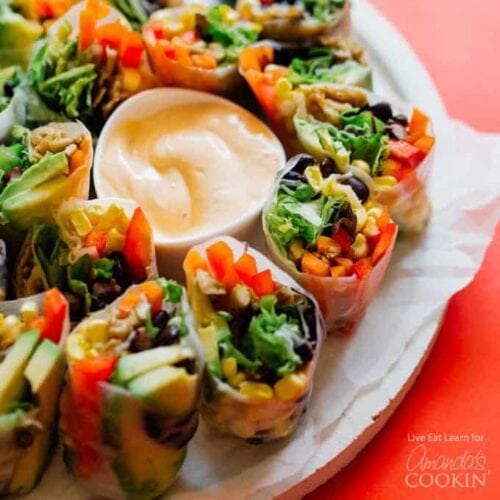 summer rolls on a plate with dip in the center