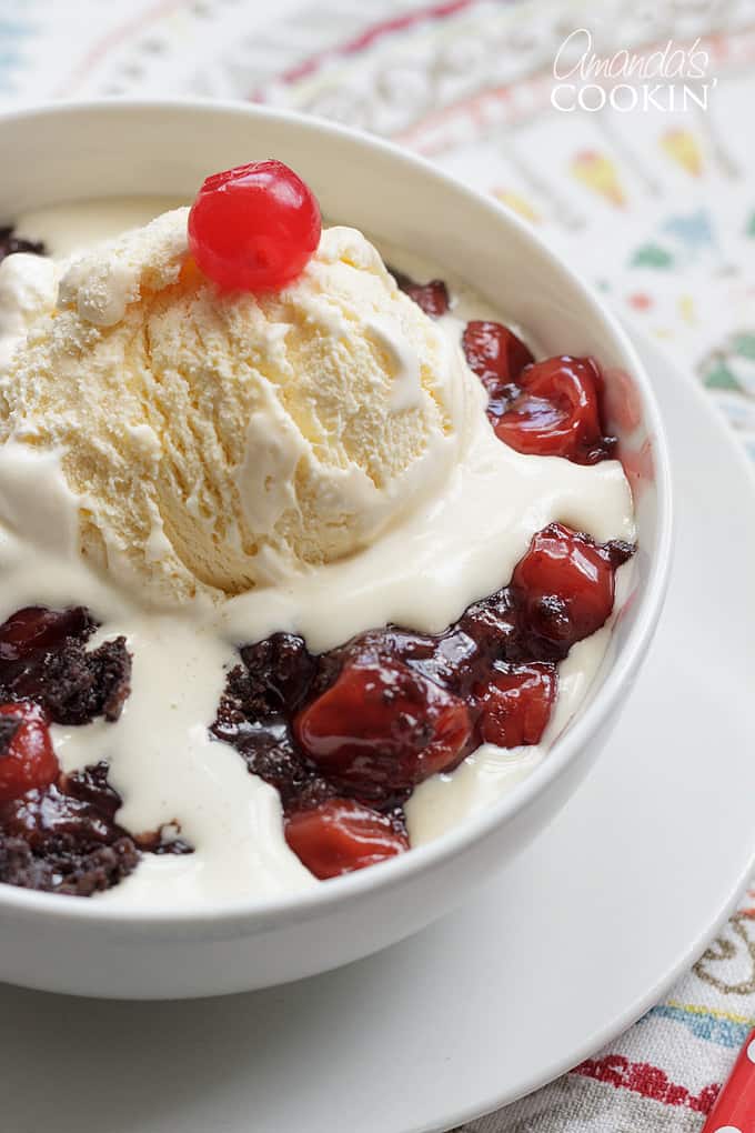 vanilla ice cream melting on chocolate cherry cobbler