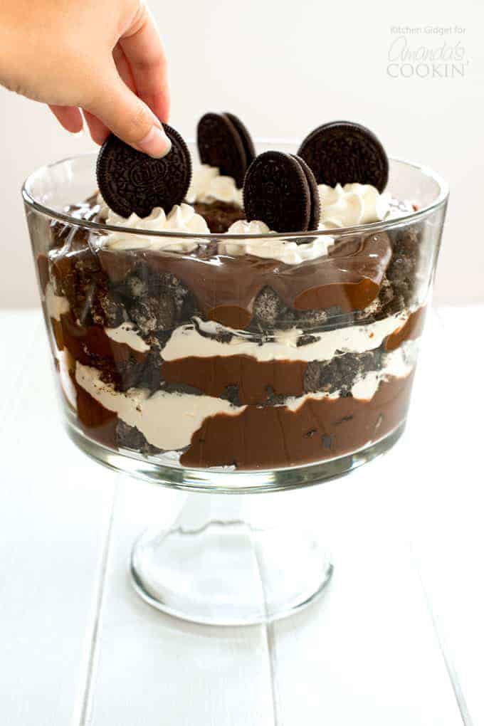 Placing an oreo on top of Chocolate Lasagna Trifle