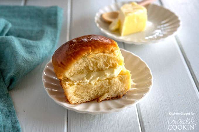 homemade hawaiian rolls on a plate with butter