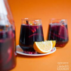pomegranate sangria with an orange wedge