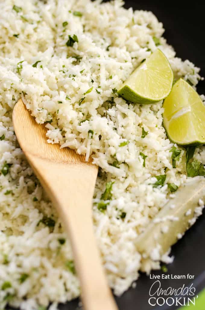 Copycat Cauliflower Chipotle Rice with lime wedges