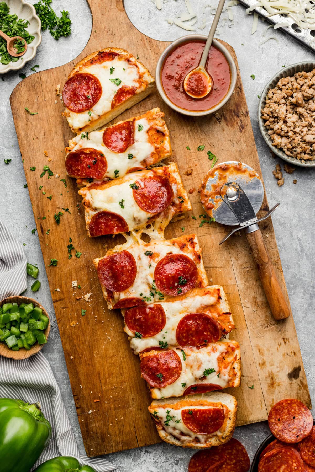 Pepperoni French Bread Pizza sliced on a wooden board