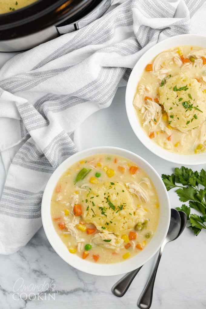 two bowls of crockpot chicken and dumplings