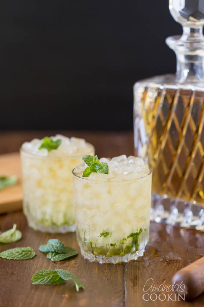 Mint Julep with whiskey bottle in background