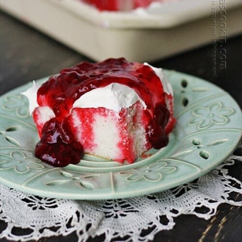 raspberry poke cake on a plate