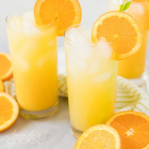 2 glasses of screwdriver cocktail garnished with orange wheels
