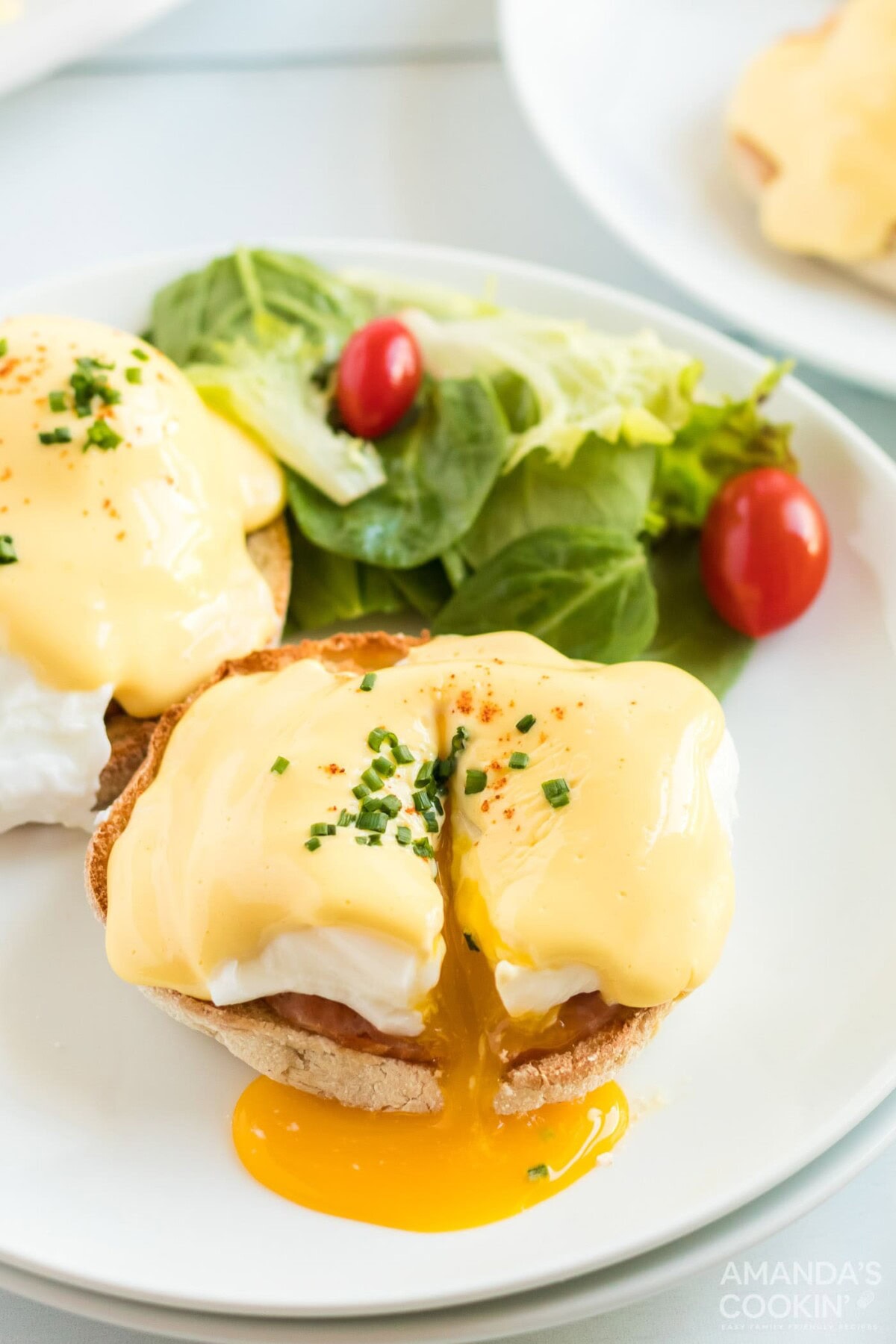 cut open eggs benedict on a plate