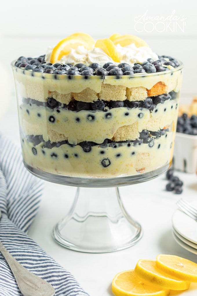 lemon blueberry trifle with a blue towel and lemons on table