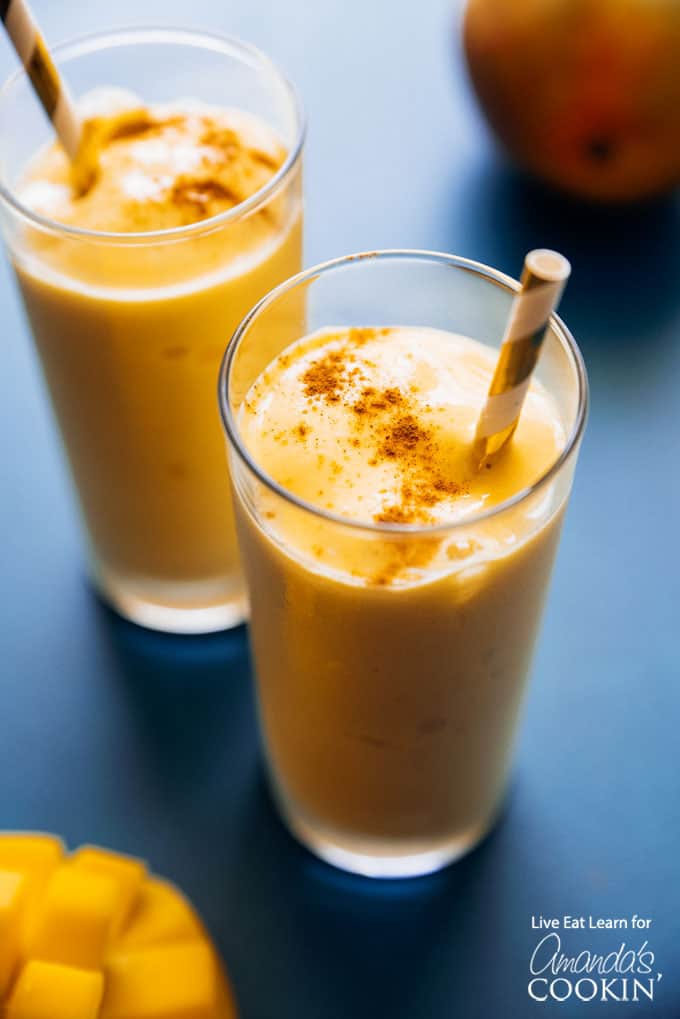 mango lassi smoothie above shot with sprinkle of cinnamon
