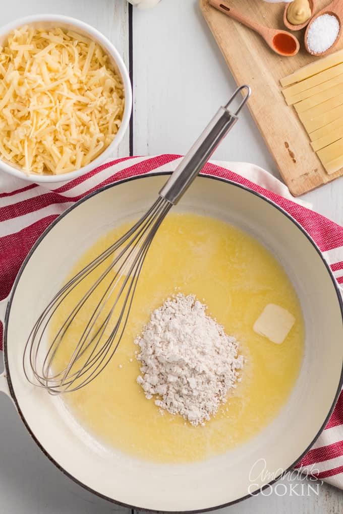 saucepan with melted butter, a whisk, and flour