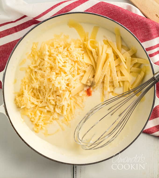 saucepan with a flour roux and shredded cheeses