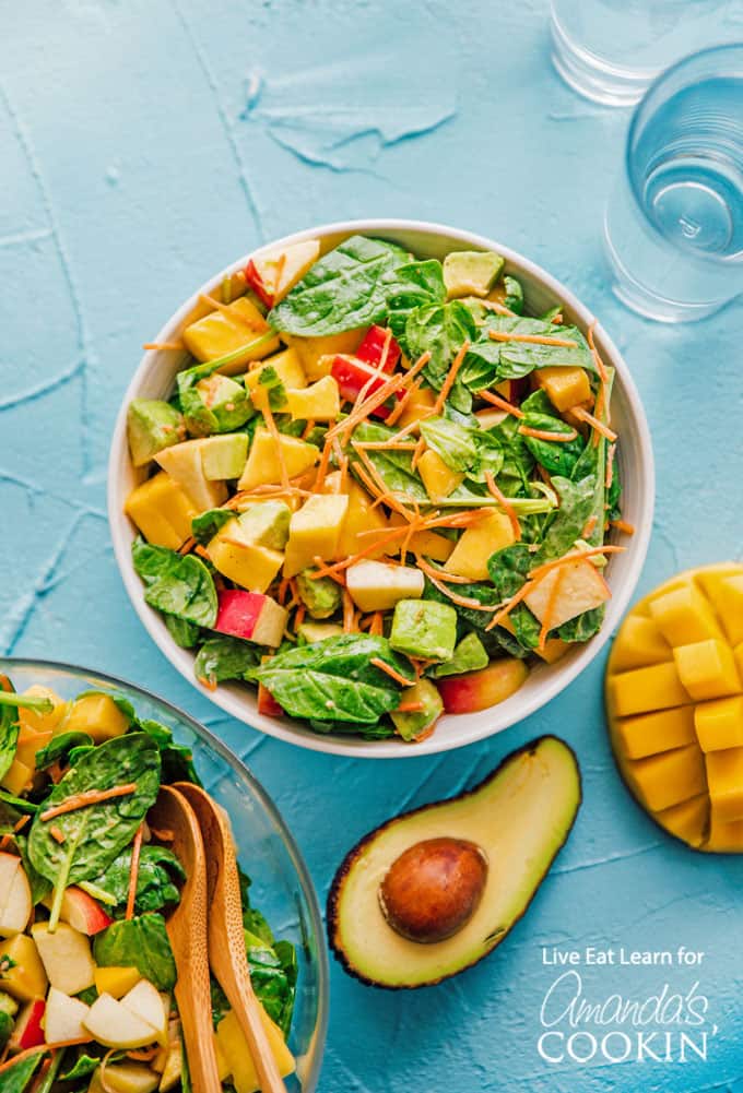 Spinach salad overhead shot with avocado, mango and apple