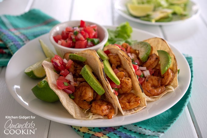 shrimp tacos on plate with avocado and pico de gallo