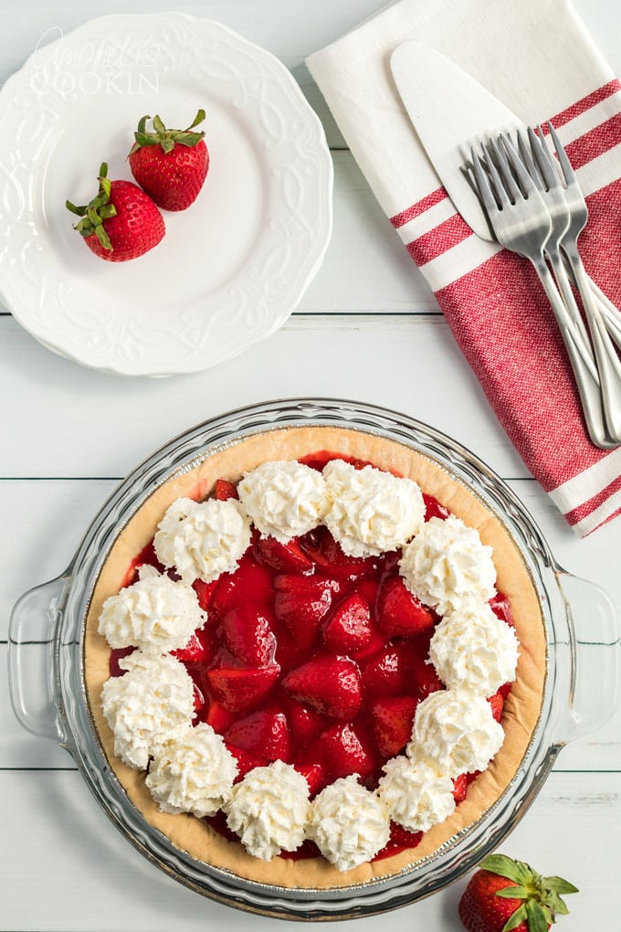 strawberry pie decorated with whipped cream