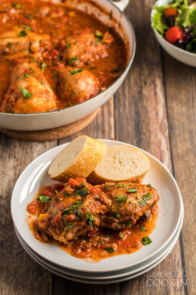 chicken cacciatore on a plate with bread