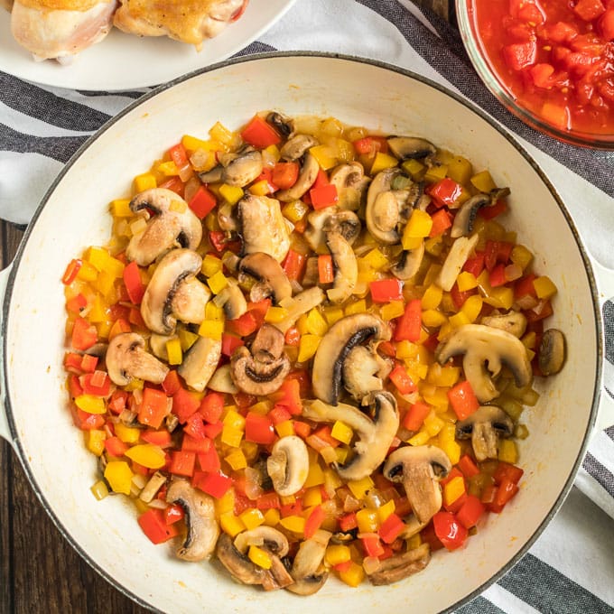 bell pepper, onions, and mushrooms sauteed in pan