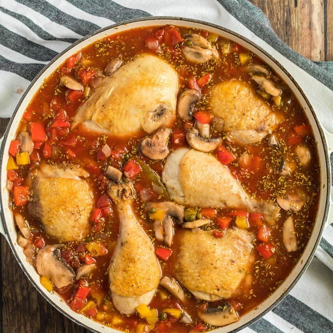 chicken pieces in sauce in pan