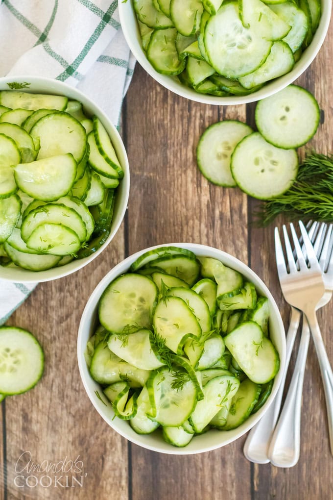 cucumber salad in serving bowls with forks