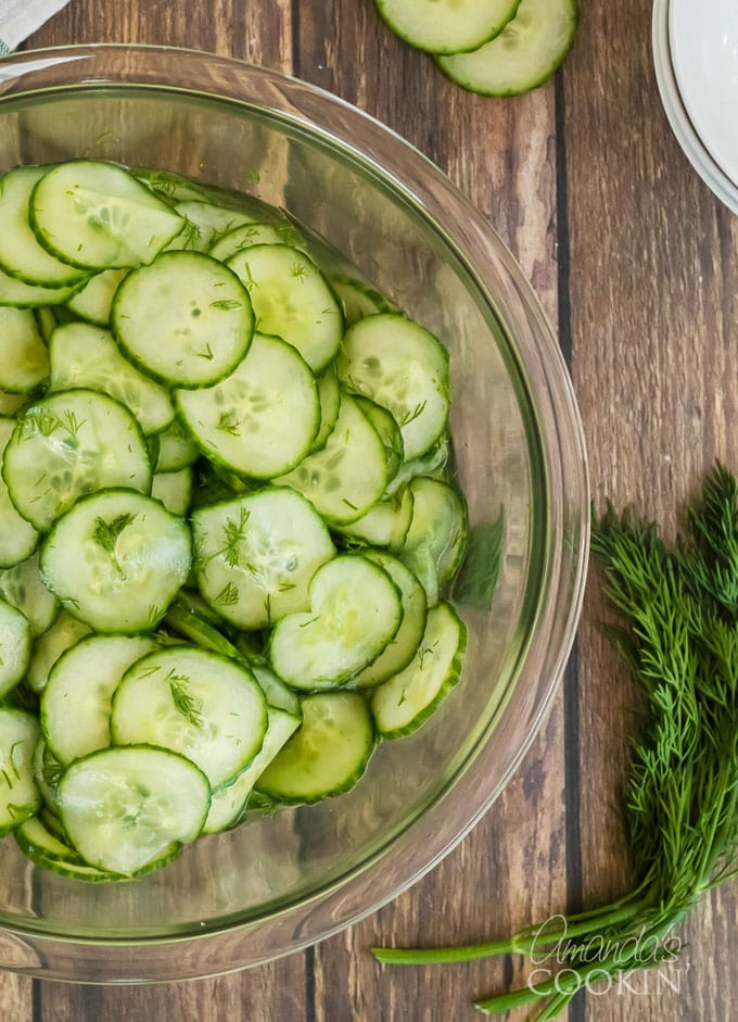 cucumber salad with vinegar dressing and fresh dill in a large bowl