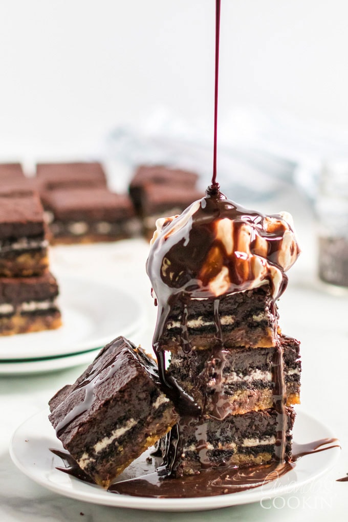 stack of Slutty Brownies with scoop of ice cream and chocolate syrup dripping on top