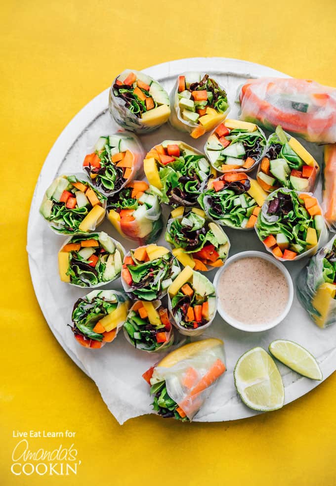Vegetable spring rolls on a plate with dipping sauce