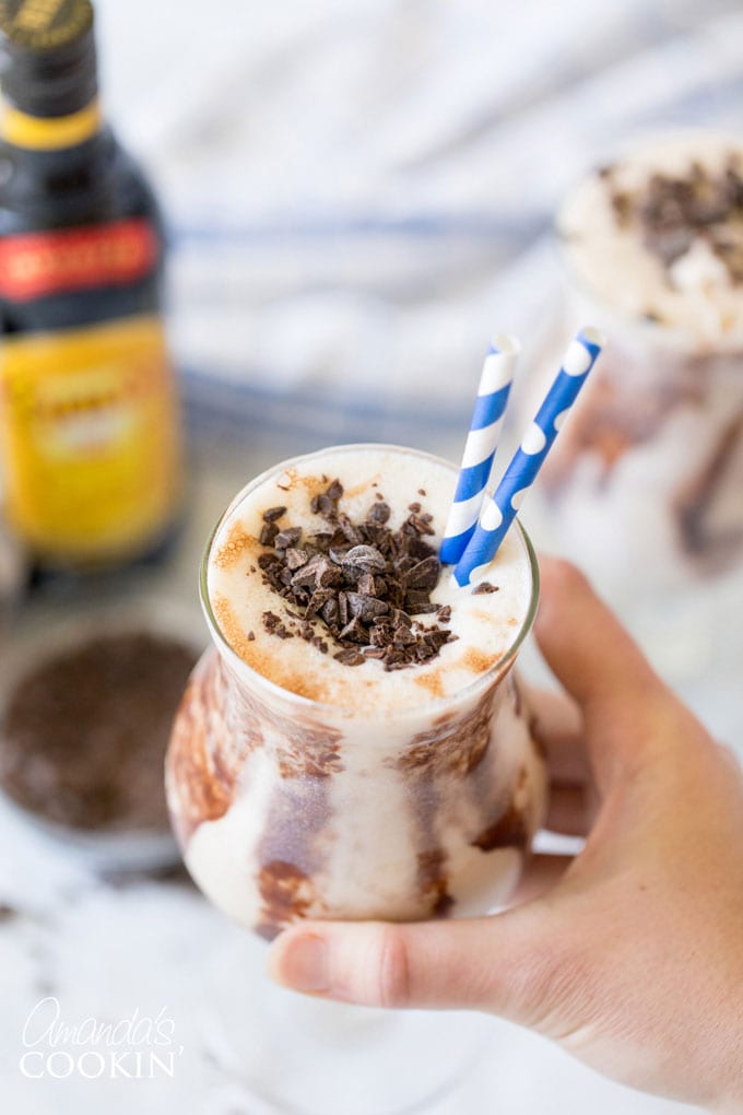 hand holding glass of frozen mudslide