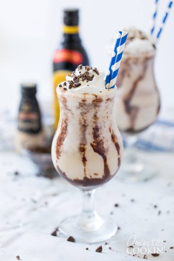 two glasses of frozen mudslides with bottles in background