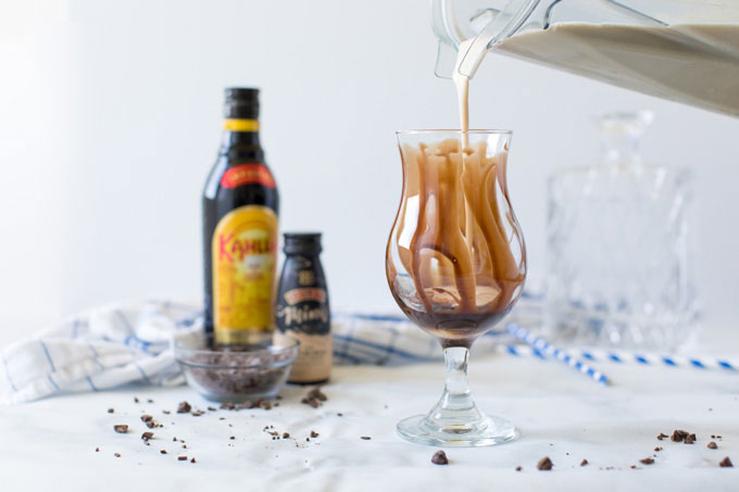 pouring blender contents into chocolate covered glass