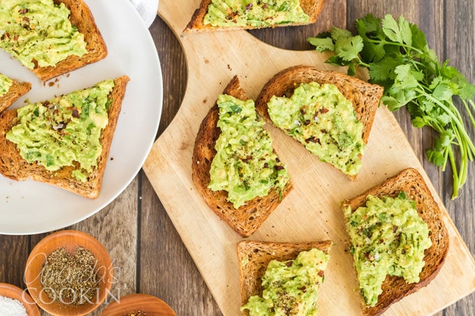 overhead shot of avocado toast slices on cutting board
