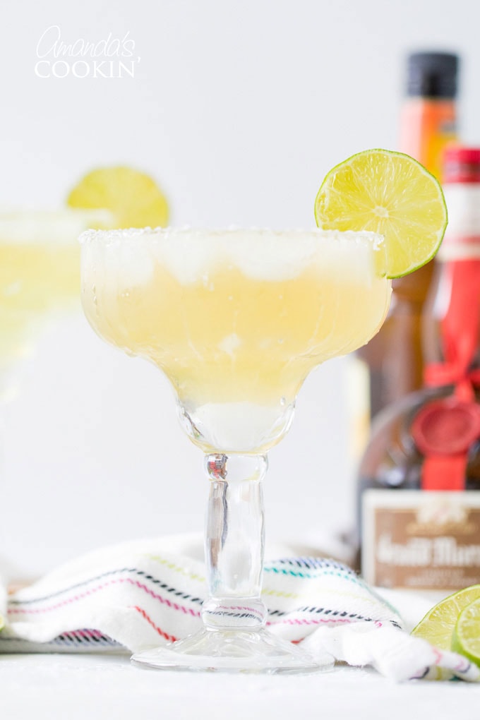 margarita on the rocks in a glass with a lime garnish