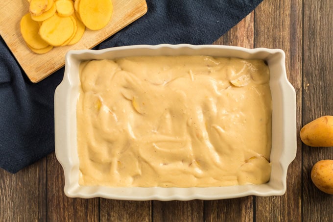 cheese sauce spread over sliced potatoes