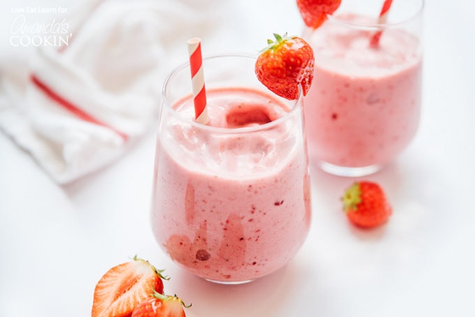 strawberry smoothies in glass with paper straws