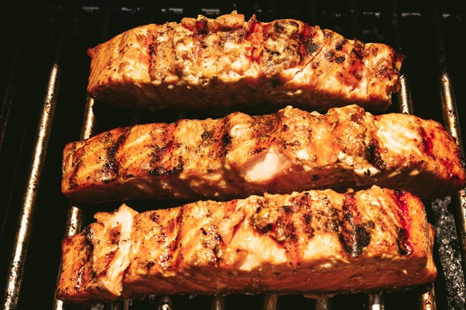 salmon filets cooking on grill