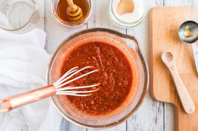 bowl of sauce with a whisk