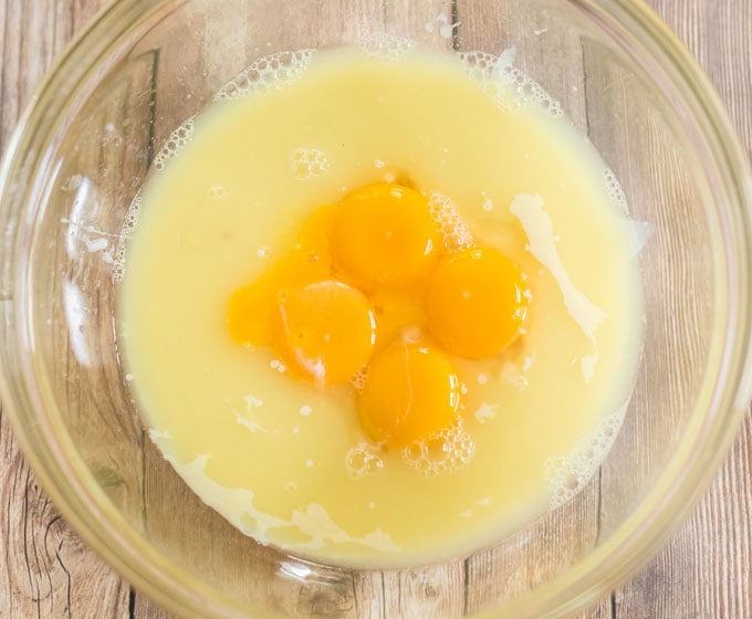 egg yolks in bowl with sweetened condensed milk