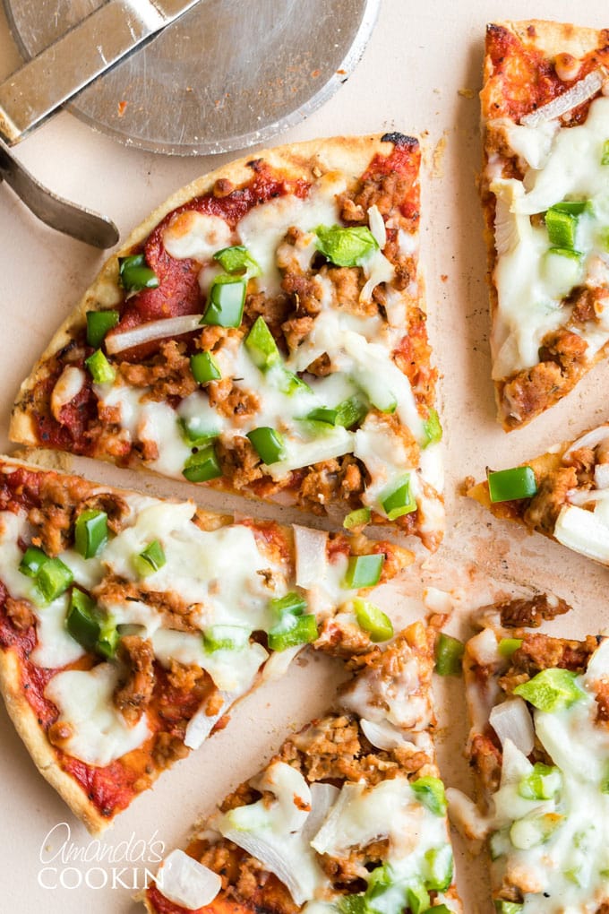 slices of homemade pizza with sausage and green pepper