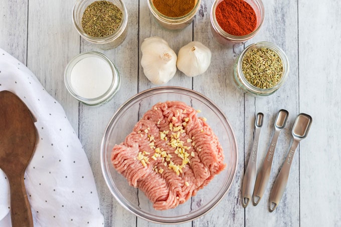 ingredients for pizza sausage, ground pork, spices and herbs