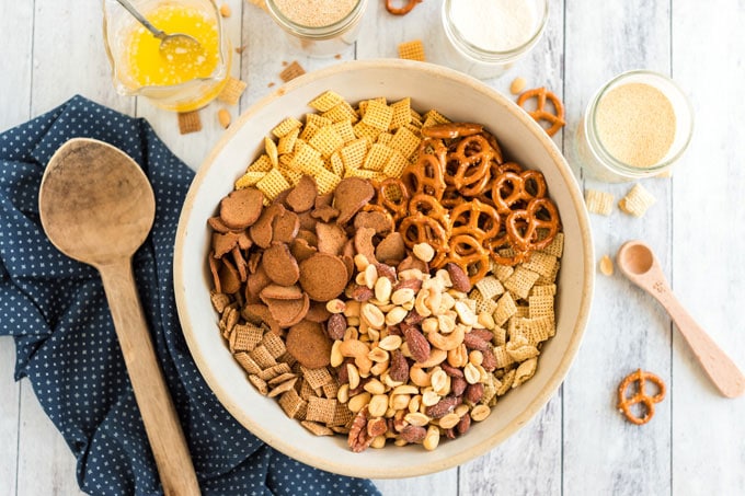 nuts, pretzels, cereal, and bagel chips in a bowl