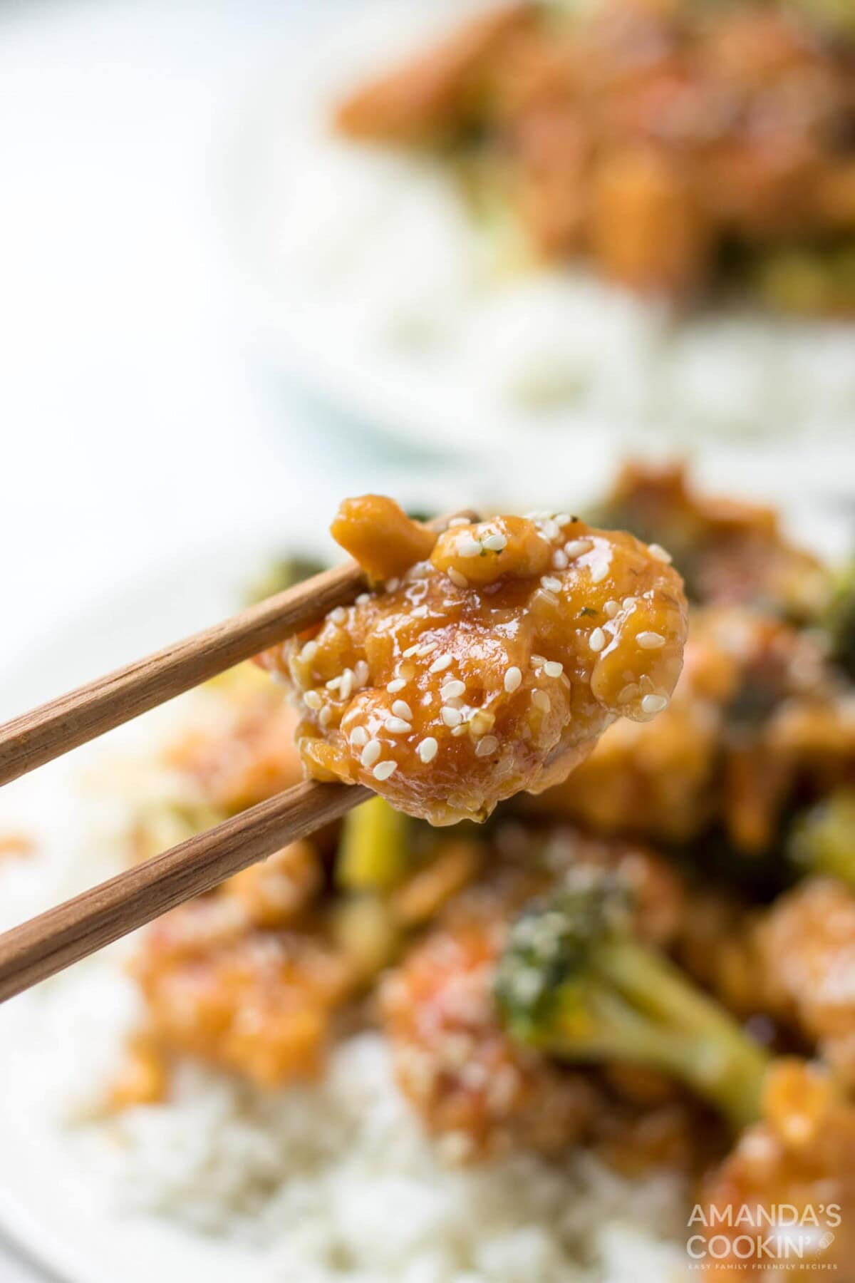chopstick holding sesame chicken