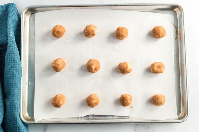 snickerdoodles cookie dough balls on baking sheet